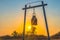 Scenery sunset behind the bell and golden Buddha