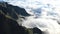 Scenery view of drifting clouds between rocky green mountains at Drakensberg