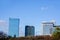 Scenery view of glass and office building on blue sky background.