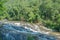 Scenery view of waterfall in the lush green forest