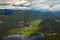 Scenic aerial panoramic view of Bohinj Lake with mountain range and valley with small village