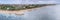 Scenic aerial panoramic view at Northern part of Sanur beach with wide very shallow shore, dark heavy clouds before rain, Bali,