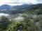 Scenic aerial shot capturing the tranquil beauty of mist-covered mountains, lush forests, and rice terraces at dawn. At Banaue, in