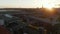 Scenic Aerial Shot of Yellow Subway Train entering Station elevated above ground in Berlin, Germany at Sunset