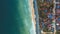 Scenic aerial view of the beach with the turquoise sea water and beautiful seaside architecture