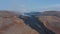 Scenic aerial view of black lava river in Fagradalsfjall, Iceland, drone flying backwards reveal otherworldly landscape