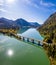 Scenic aerial view of the bridge over Lake Sylvenstein with beautiful reflections. Alps Karwendel Mountains in the back