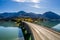 Scenic aerial view of the bridge over Lake Sylvenstein with beautiful reflections. Alps Karwendel Mountains in the back