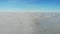 Scenic aerial view of clouds. Drone is flying in blue sky through clouds ahead