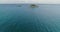 Scenic aerial view of drone flying over calm ocean with coral reef to tropical paradise island