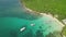 Scenic aerial view of a green lagoon with boats floating on the pristine water.