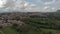 Scenic aerial view of Italian countryside with village and hills and mountain