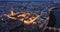 Scenic aerial view of lighted Roman bridge across Guadalquivir river and Mezquita-Catedral on background with Cordoba