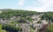 A scenic aerial view of the town of hebden bridge in west yorkshire with hillside streets of stone houses and roads between trees