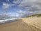 Scenic autumn sandy beach with waves and dunes in Sylt