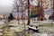 Scenic autumn view with the first snow on a dirt wet road in the mountains, trees and forest in the snow and hoarfrost on the