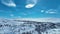 Scenic backward aerial video above birch forest, valleys, frozen snowy mountains in Sweden, Norway. Subarctic landscape of Lapland