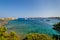 Scenic bay with turquoise water and sailing boat anchorage.