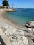 Scenic beach landscape featuring an ocean shoreline with rocky outcroppings and pebbles