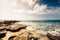 scenic beach landscape, seaside details with rocks and sunset.