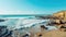 Scenic beach landscape with waves and rocky shore