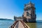 Scenic Belem Tower and wooden bridge miroring with low tides on Tagus River. Torre de Belem is Unesco Heritage and icon of Lisbon