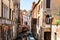 Scenic canal with bridge and old buildings with potted plants in Venice, Italy