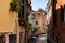 Scenic canal with bridge and old buildings with potted plants in Venice, Italy