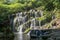 Scenic cascade Banyu Wana Amertha waterfall in Bali. Beautiful waterfall and green forest Resting Place and relax time.