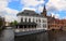 Scenic city view of Bruges canal with beautiful medieval Flemish colored houses .