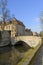 Scenic city view of Bruges canal, bridge and flemish house