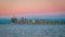 Scenic cityscape of Detroit with a pink sunset sky and waterscape