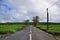 Scenic clean quiet tranquil road in rural or outskirt area with tea plantation on both sides and blue sky