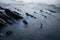 Scenic close up view on rocks in atlantic ocean in socoa, basque country, france in long exposure, creative background design