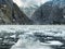 Scenic coastal landscape with steep glacially polished cliffs and floating ice at Tracy Arm Fjord