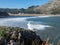 Scenic Coastal View Near Laredo, Cantabria, Northern Spain. Sea, blue sky, Surfers Riding   Waves