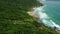 Scenic coastline with beach, rocks and ocean with waves in Brazil. Aerial view