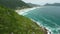 Scenic coastline with mountains and ocean with waves in Brazil. Aerial view