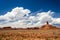 Scenic desert landscape with red sand and rocks and beautiful clouds in the blue sky