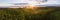 Scenic drone panorama photo of foggy sunrise over forest, landscape in North Sweden, golden sun light beams and shadows.