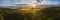 Scenic drone panorama photo of very foggy sunrise over forest, landscape in North Sweden, golden sun light beams and shadows.