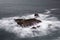 Scenic drone view of a stone in the middle of the calm sea