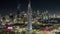 Scenic Dubai downtown skyline timelapse at night. Rooftop view of Sheikh Zayed road with numerous illuminated towers.