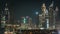 Scenic Dubai downtown skyline timelapse at night. Rooftop view of Sheikh Zayed road with numerous illuminated towers.