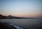 Scenic evening shot at Santa Amalia beach with a view of buildings and hills in front of a sea