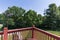 Scenic exterior of a backyard with trees seen from the balcony of a house