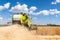 Scenic front view Big powerful industrial combine harvester machine reaping golden ripe wheat cereal field on bright