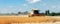 Scenic front view Big powerful industrial combine harvester machine reaping golden ripe wheat cereal field on bright