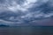 Scenic gray-blue clouds during sunrise over coastline with sandy beach and clear sea water in Alcamo Marina, small town in Sicily
