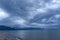 Scenic gray-blue clouds during sunrise over coastline with sandy beach and clear sea water in Alcamo Marina, small town in Sicily